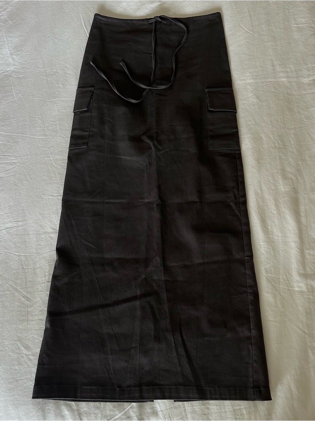 Black ankle-length cargo skirt with a tie belt and patch pockets
